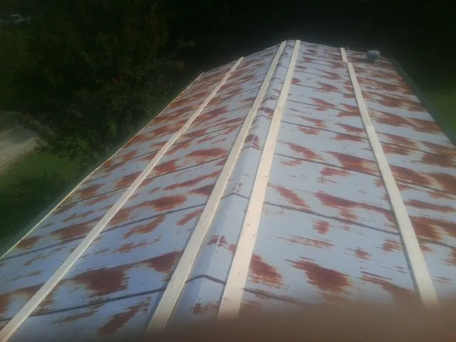 Rusted metal roof panels with new wood purlins before replacement — Storm Damage Roof Repair in Monetta by Roofing Brothers